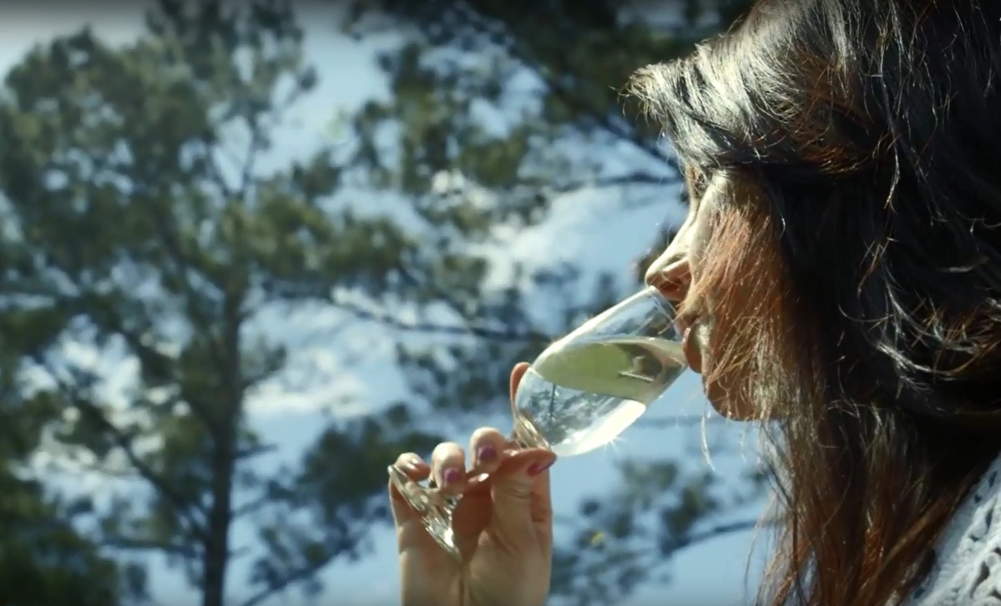 pretty girl drinking mead outside by the trees
